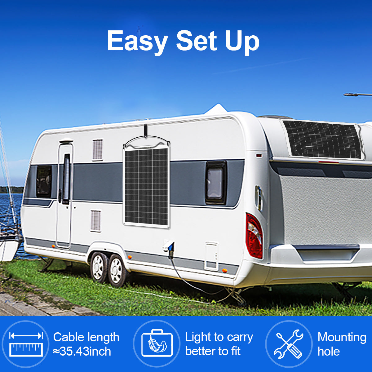 White caravan with solar panels on a grassy area with a blue sky.